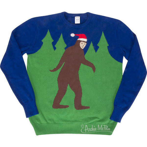 Festive blue and green holiday sweater featuring Santa Sasquatch walking through pine trees, perfect for ugly sweater parties and Bigfoot enthusiasts