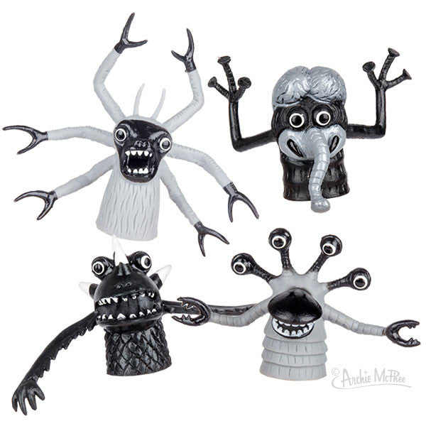 Set of four black and white rubber finger monsters with quirky designs, including multiple eyes, tentacle-like arms, and exaggerated features, perfect for creative play and nostalgic noir-style puppet shows.