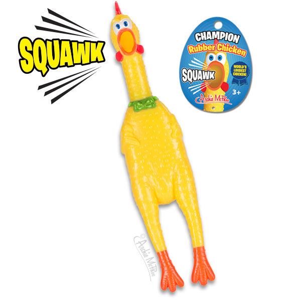 Champion Rubber Chicken toy with bright yellow body, orange feet, and red comb. Product packaging shows "SQUAWK" text and blue ribbon. Soft vinyl squeaking toy for ages 3+, designed to make noise when squeezed.