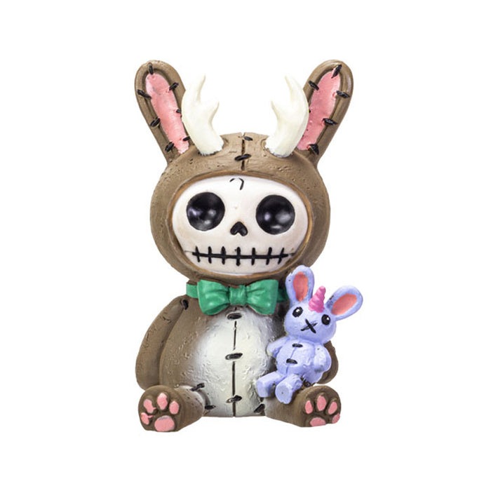 Furrybones Bun Bun Lope figurine, skeleton in jackalope costume with antlers and brown fur, holding small purple unicorn doll, wearing green bowtie, sitting pose with pink paw pads visible