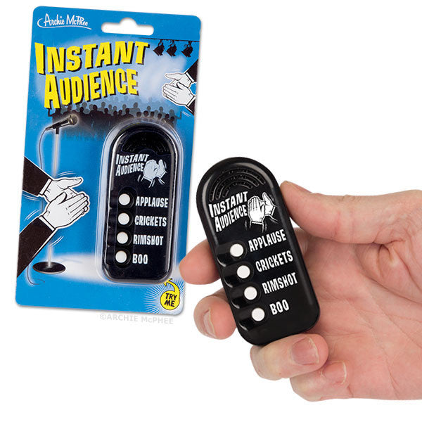 Instant Audience handheld device with four sound effects buttons for applause, crickets, rimshot, and boo, shown in packaging and held in hand, perfect for creating instant crowd reactions