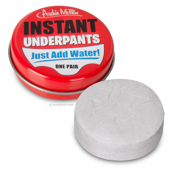 Red tin of Instant Underpants by Archie McPhee with 'Just Add Water!' text, next to a white compressed pellet of disposable underpants