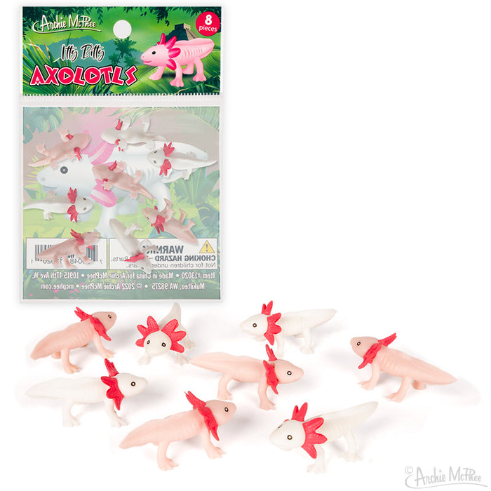 Bag of 8 tiny pink and white axolotl toys with red gills, packaged in clear plastic with green leafy background. Product image shows both packaged and unpackaged miniature vinyl axolotls for size reference.