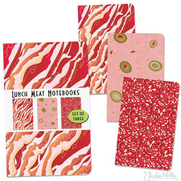 Set of three creative notebooks designed to look like lunch meats: bacon with red and white stripes, olive loaf with green circles on pink, and salami with red speckled pattern. Product packaging shows mini versions of the notebooks and text "Lunch Meat Notebooks Set of Three".