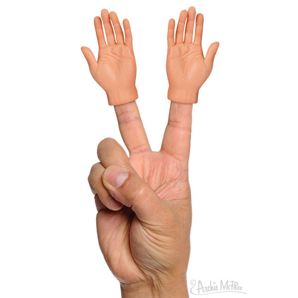 Pair of miniature hands worn on fingertips, light skin tone, making peace sign gesture on real hand, novelty finger puppets for fun and entertainment