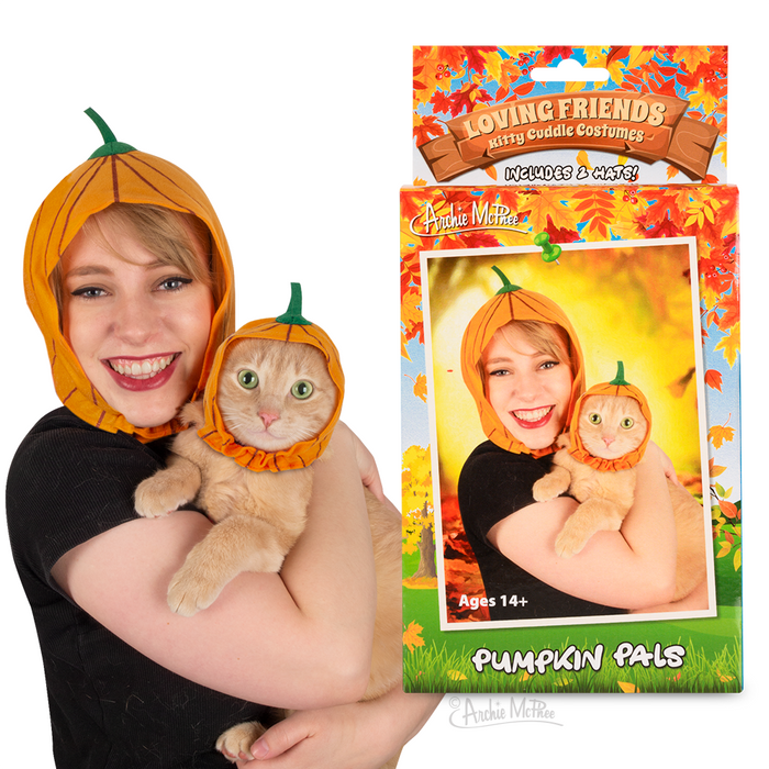 Matching pumpkin-shaped felt hats for owner and cat, packaged as "Loving Friends Kitty Cuddle Costumes: Pumpkin Pals". Woman holding orange cat, both wearing orange pumpkin hats with green stems. Product box features autumn-themed design and sample image.