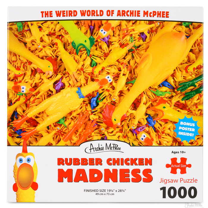 Colorful 1000-piece jigsaw puzzle box featuring a chaotic pile of yellow rubber chickens with scattered blue, green, and purple accents. Text reads "The Weird World of Archie McPhee" and "Rubber Chicken Madness".