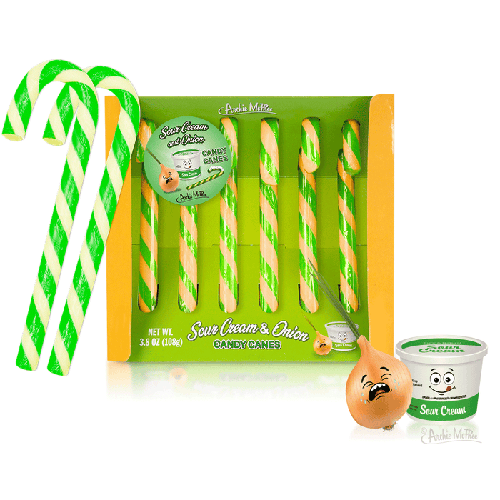 Box of Sour Cream & Onion Candy Canes featuring green and yellow striped candy canes, with product packaging showing a cartoon onion and sour cream container. Two candy canes are displayed outside the box, showcasing their unique color pattern.