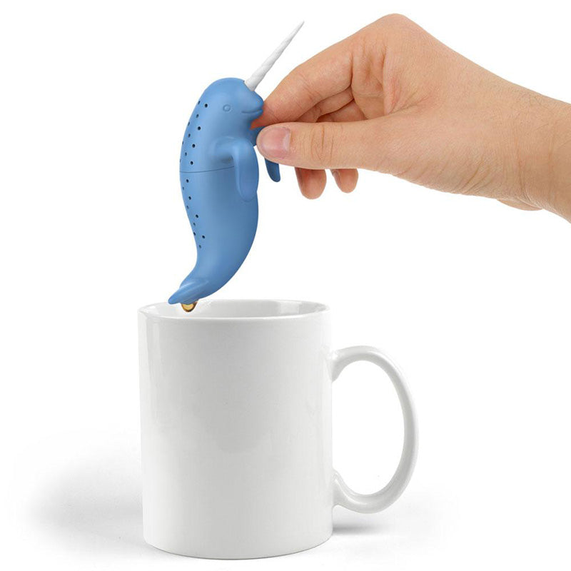 Narwhal tea infuser with a white tea cup