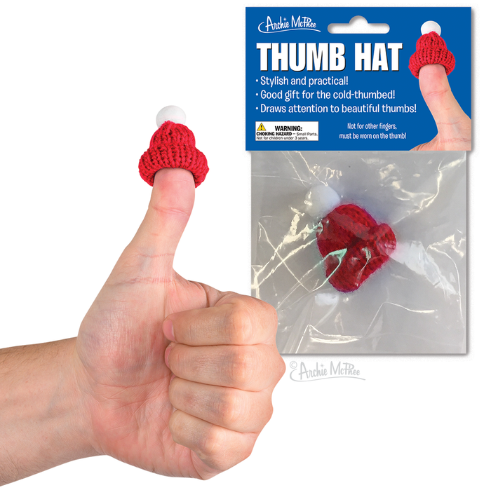 Red knitted thumb hat worn on a thumbs-up hand gesture, with product packaging displaying "Thumb Hat" and benefits. Miniature novelty item for stylish and practical cold-thumb coverage.